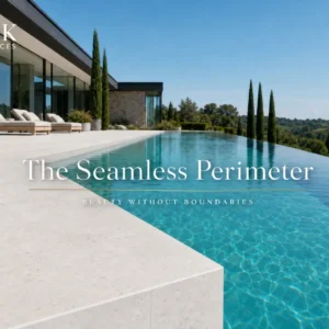 A luxury outdoor swimming pool perimeter featuring Crystal Bianco L-shape porcelain coping with a seamless infinity edge drop face.