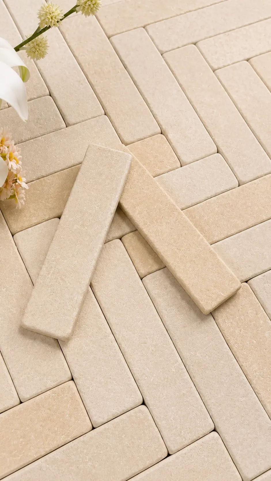 Close detail of tumbled sandstone cobbles laid in herringbone