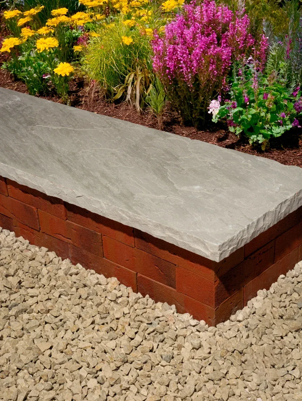 Kandla Grey sandstone coping on a garden wall