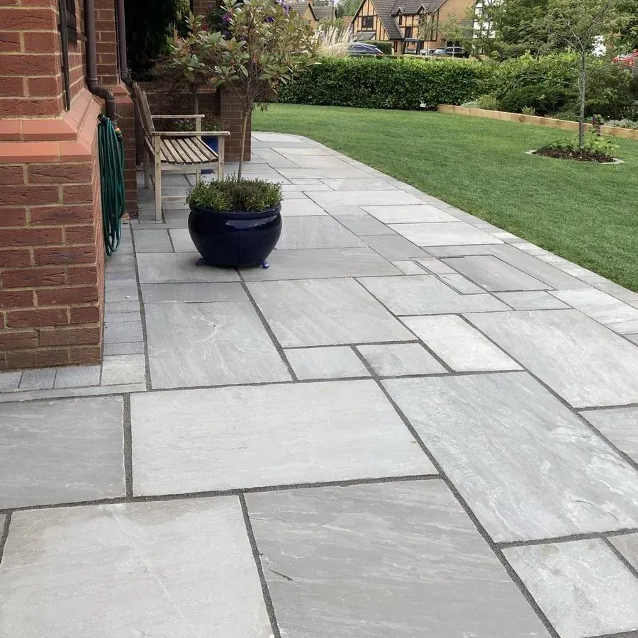 Kandla Grey sandstone patio next to a lawn